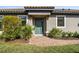 Inviting front entrance with a stylish teal door, brick walkway, and lush landscaping at 11125 Callisia Dr, Odessa, FL 33556