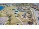 Aerial view of the community playground with multiple play structures, picnic shelters, and open green space at 18304 Roseate Dr, Lutz, FL 33558