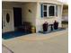 Close-up of the home entrance with a cozy bench, decorative planters, and a colorful welcome mat at 322 S Port Royal Ln, Apollo Beach, FL 33572
