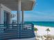 Balcony view of the beach with blue railing, perfect for relaxing and enjoying the scenery at 3910 Gulf Blvd # 400, St Pete Beach, FL 33706