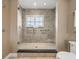 Walk-in shower offers neutral tile, glass enclosure and convenient grab bars at 3910 Gulf Blvd # 400, St Pete Beach, FL 33706