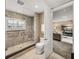 Neutral bathroom features large walk-in shower and view of the comfortable living room at 3910 Gulf Blvd # 400, St Pete Beach, FL 33706