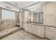 Bathroom featuring a walk-in shower with travertine tile and a glass block window at 3910 Gulf Blvd # 400, St Pete Beach, FL 33706