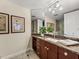 Bathroom vanity with granite countertop, wood cabinets and large mirror at 3910 Gulf Blvd # 400, St Pete Beach, FL 33706