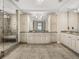 Bathroom features a tiled walk-in shower, dual vanities and granite countertops at 3910 Gulf Blvd # 400, St Pete Beach, FL 33706