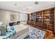Bedroom with a large bookcase, desk and plush rug at 3910 Gulf Blvd # 400, St Pete Beach, FL 33706