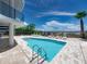 Beautiful community pool with poolside seating and beach access, perfect for enjoying the sunny outdoors at 3910 Gulf Blvd # 400, St Pete Beach, FL 33706