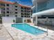 Gorgeous community pool with a beautiful water feature and lounge seating, providing residents a luxurious outdoor retreat at 3910 Gulf Blvd # 400, St Pete Beach, FL 33706