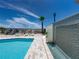 Community pool with tiled waterfall feature, beach access, and luxurious lounging, promising a serene outdoor experience at 3910 Gulf Blvd # 400, St Pete Beach, FL 33706