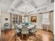 Bright dining room with hardwood floors, coffered ceilings, and elegant chandelier at 3910 Gulf Blvd # 400, St Pete Beach, FL 33706