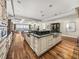 Bright kitchen features a large island with dual sinks, dark countertops, and beach views at 3910 Gulf Blvd # 400, St Pete Beach, FL 33706