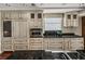 Traditional-style kitchen with custom cabinets, granite countertops, and stainless steel appliances at 3910 Gulf Blvd # 400, St Pete Beach, FL 33706