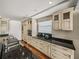 Bright kitchen features custom cabinetry, dark countertops, built-in appliances, and ample storage space at 3910 Gulf Blvd # 400, St Pete Beach, FL 33706