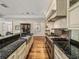 Contemporary kitchen showcases stainless steel appliances, dark granite countertops, and wood floors at 3910 Gulf Blvd # 400, St Pete Beach, FL 33706