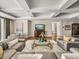 Bright living room offers coffered ceilings, ocean views, and a comfortable sectional couch at 3910 Gulf Blvd # 400, St Pete Beach, FL 33706