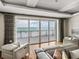 A light filled living room with floor-to-ceiling windows providing ocean views at 3910 Gulf Blvd # 400, St Pete Beach, FL 33706