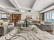 Bright living room features coffered ceilings, a decorative rug, and a large sectional couch at 3910 Gulf Blvd # 400, St Pete Beach, FL 33706