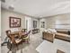 A living room and dining area with a table and chairs plus a couch with white pillows at 3910 Gulf Blvd # 400, St Pete Beach, FL 33706