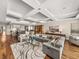 Expansive living room featuring coffered ceilings, hardwood floors, and an open concept design to the kitchen at 3910 Gulf Blvd # 400, St Pete Beach, FL 33706
