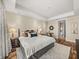 Bright primary bedroom featuring a tray ceiling, wood floors, area rug, and ensuite bathroom at 3910 Gulf Blvd # 400, St Pete Beach, FL 33706