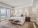 Tranquil main bedroom with balcony access, ocean view, a plush bed, and stylish furnishings at 3910 Gulf Blvd # 400, St Pete Beach, FL 33706