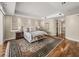 Comfortable main bedroom with hardwood floors, ocean views, and a stylish accent rug at 3910 Gulf Blvd # 400, St Pete Beach, FL 33706