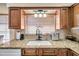 Close-up of a kitchen sink area, featuring granite countertops and wooden cabinetry at 5229 26Th N Ave, St Petersburg, FL 33710