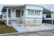 Charming single-story mobile home featuring bright white siding and a covered entry for easy access at 5335 Fairfield S Ave # 78, Gulfport, FL 33707