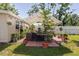 Cozy backyard featuring a covered patio, lush plants, and comfortable seating area at 6145 55Th N Ave, St Petersburg, FL 33709