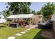 Spacious backyard with a covered patio area, hot tub, and well-maintained lawn at 6145 55Th N Ave, St Petersburg, FL 33709
