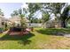 Expansive backyard with a covered patio, storage shed, and ample green space at 6145 55Th N Ave, St Petersburg, FL 33709