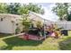 Charming outdoor living: Covered patio with seating and lush greenery in the backyard at 6145 55Th N Ave, St Petersburg, FL 33709