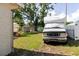 Expansive grassy backyard features an RV, outdoor patio, and shed creating a versatile space at 6145 55Th N Ave, St Petersburg, FL 33709