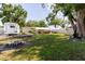 Spacious backyard featuring a fire pit, RV parking, and a covered patio at 6145 55Th N Ave, St Petersburg, FL 33709