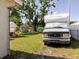 Large backyard with well-maintained lawn, RV, outdoor seating, and shed offering ample space at 6145 55Th N Ave, St Petersburg, FL 33709