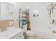 Cozy bathroom featuring a shower and tub combo, white vanity, and beach-themed decor at 6145 55Th N Ave, St Petersburg, FL 33709