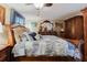 Cozy bedroom with a dark wood sleigh bed, matching furniture, and a ceiling fan at 6145 55Th N Ave, St Petersburg, FL 33709
