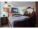 Cozy bedroom with a dark wood sleigh bed, matching furniture, and a ceiling fan at 6145 55Th N Ave, St Petersburg, FL 33709