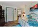 Charming bedroom with wood floors, white metal bed frame, and beach-themed decor at 6145 55Th N Ave, St Petersburg, FL 33709