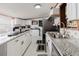 Bright kitchen with white cabinets, stainless steel appliances, and a granite countertop island at 6145 55Th N Ave, St Petersburg, FL 33709