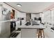Bright kitchen featuring white cabinets, stainless steel appliances, and a large central island at 6145 55Th N Ave, St Petersburg, FL 33709