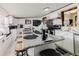 Updated kitchen with stainless appliances, granite countertops, and a large breakfast bar at 6145 55Th N Ave, St Petersburg, FL 33709