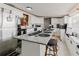Bright kitchen with white cabinets, stainless steel appliances, granite countertops, and breakfast bar at 6145 55Th N Ave, St Petersburg, FL 33709