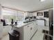Bright kitchen with white cabinets, stainless steel appliances, and a granite countertop island with a breakfast bar at 6145 55Th N Ave, St Petersburg, FL 33709