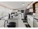 Bright kitchen with white cabinets, stainless steel appliances, and a granite countertop island at 6145 55Th N Ave, St Petersburg, FL 33709