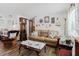 Bright and airy living room with wood floors, a comfortable leather sofa, and nautical-themed decor at 6145 55Th N Ave, St Petersburg, FL 33709