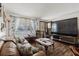 Cozy living room with hardwood floors, comfortable seating, large TV, and natural light from the window at 6145 55Th N Ave, St Petersburg, FL 33709