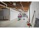Unfinished basement offering space for storage, gym, or recreation, with access to the backyard at 7418 Bay Dr, Tampa, FL 33635