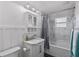 Bright bathroom featuring marble tile, a shower-tub combination, and modern vanity with medicine cabinet for ample storage at 7418 Bay Dr, Tampa, FL 33635