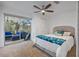 Bedroom features a window to the outdoor living space and plush carpeting at 7418 Bay Dr, Tampa, FL 33635